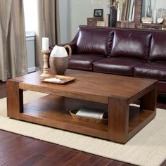 a living room with a brown leather couch and coffee table