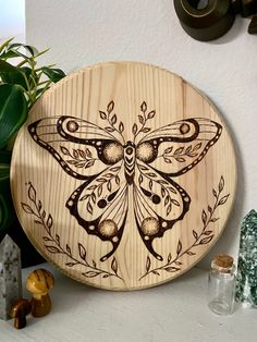 a wooden plaque with a dragonfly on it