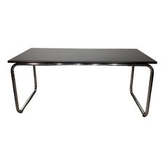 a black table sitting on top of a metal frame