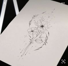 a drawing of some flowers on a piece of paper with scissors in front of it