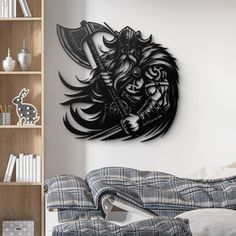 a bedroom with a bed, bookshelf and wall decoration