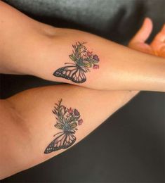 two women with tattoos on their legs, one has a butterfly and the other has flowers