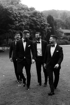 three men in tuxedos are walking together