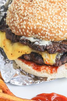 a cheeseburger with fries on the side and ketchup