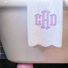 a white bath tub sitting next to a pink toilet