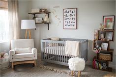 a baby's room with a crib, chair and bookshelf