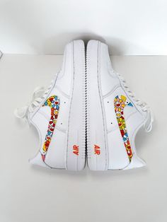 This Takashi Murakami Custom Air Force 1 is a one-of-a-kind shoe. This unique collaboration between Takashi Murakami and Nike Air Force 1 features custom prints on the iconic silhouette, as well as custom detailing. With its bold design, this shoe is perfect for making a statement. Exactly as shown in the pictures. 📷 Brand New & Authentic. 💯 Hand Painted with attention to detail. 👨‍🎨 Waterproof and Flexible. ❤️ Unisex model. Please refer to the Size Chart. 👟👫 Free Worldwide Shipping. ✈ Artistic White Sneakers With Custom Artwork, White Leather Sneakers With Custom Artwork, Custom Sneakers Nike, Nike Air Force 1s, Custom Kicks, Custom Nike Shoes, Custom Air Force 1, Takashi Murakami, White Leather Sneakers