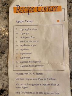 a recipe for apple crisp is on the counter next to a paper towel with instructions