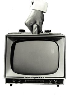 an old television with a hand on top of it and the tv is black and white