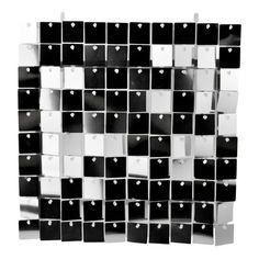 a black and white wall with lots of cubes on the side, as if it were made out of metal