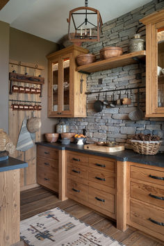 a kitchen with wooden cabinets and black counter tops