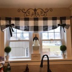 a kitchen window with a black and white checkered valance