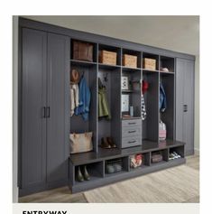 a room with some gray cabinets and shoes on the shelf next to it is a rug