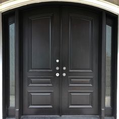 two black double doors are shown in front of a house