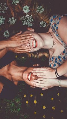 three women with their hands on top of each other