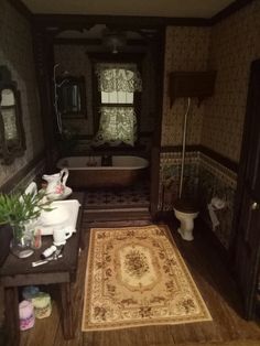 a bathroom with a rug, sink and bathtub in the middle of the room