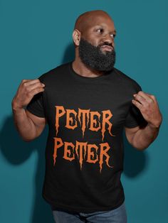 a man with a beard wearing a black shirt that says peter petter on it