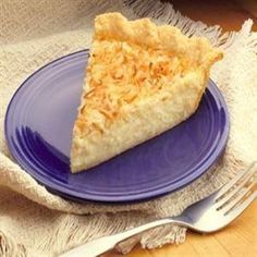 a slice of coconut pie on a blue plate