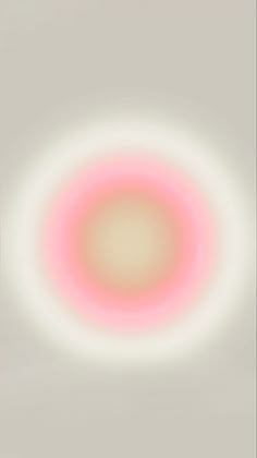 a white and pink circle is shown in the middle of a gray background with an orange center