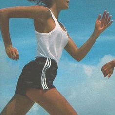 a man and woman are running together in the air with their hands out to each other