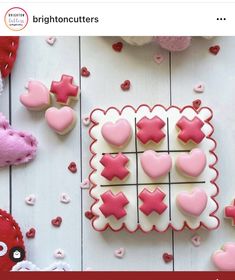 some pink and white decorated cookies on a table