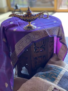 a purple table cloth on top of a wooden stand