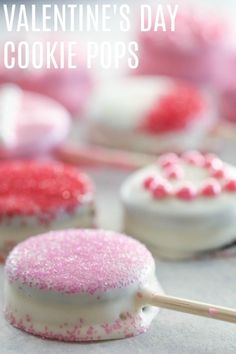 valentine's day cookie pops with pink and white sprinkles on them