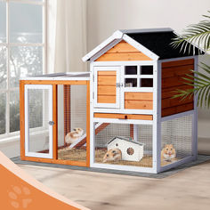 a small wooden house with two hamsters in it