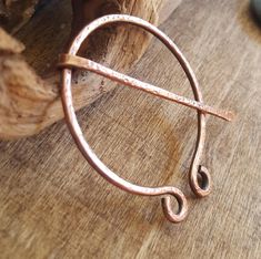 Hand forged, hammered copper cloak pins, cowl pins, scarf pins, sweater pins, kilt pins, hat pins. * This is a medium sized brooch pin with curled or looped end detail.  * Approx 2" diameter, which is my medium size. * 10 gauge pure solid copper recycled electrical wire.  * Moves freely, but the pin will not slide off.  If you want a matching set, order them together at the same time so I can make them as similar as possible to eachother. Since these are all handmade they will vary slightly from the example.  Penannular means incomplete circle, and these brooches were originally designed as a utilitarian cloak fastener during the iron age. Often known as Celtic Brooches, worn by the Romans, Vikings, Irish, and Scottish among others.  Simple, minimalist design. Perfect for renaissance fairs Irish Shawl, Cloak Pin, Sca Costumes, Copper Brooch, Kilt Pins, Sweater Pin, Larp Costume