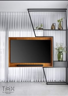 an entertainment center with shelves and a flat screen tv mounted to the side of it