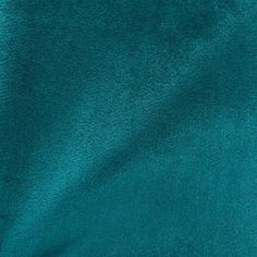 a close up view of the teal green velvet fabric that is very soft and shiny