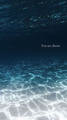 the water is very clear and blue with an inspirational quote on it that says you are chosen