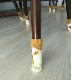 the legs of two people wearing socks with polka dots on them are standing under a table