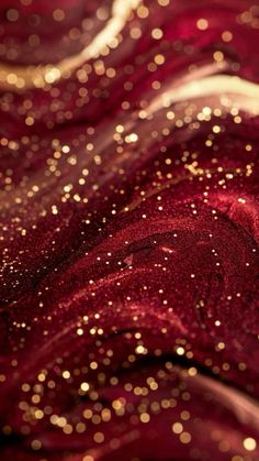 red and gold glitter fabric with lots of small dots on it's surface, close up