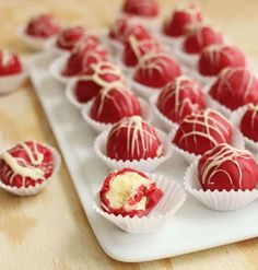 chocolate covered desserts sit on a white tray