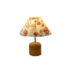 a lamp that is sitting on top of a wooden base with a flower print shade