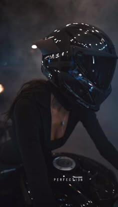 a woman wearing a motorcycle helmet on top of a turntable