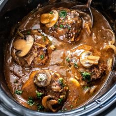 a slow cooker filled with meat and mushrooms