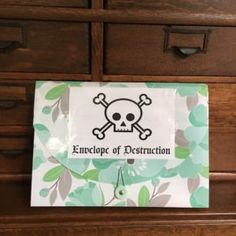 a paper bag with a skull and crossbones on it sitting on a dresser