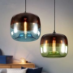 two hanging lights that are next to each other