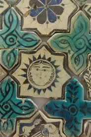 some blue and green tiles with designs on them