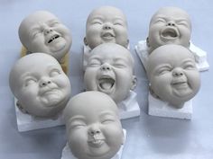 five baby heads with mouths open and laughing