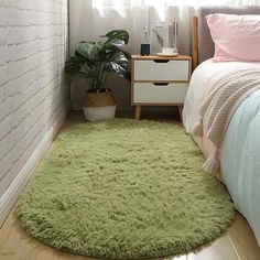 a bedroom with a green rug on the floor