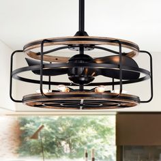 an industrial style ceiling fan with wooden blades and metal cage around it's center