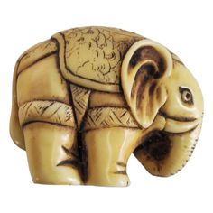 an elephant figurine is shown on a white background