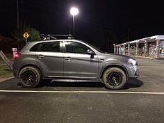 a car parked in a parking lot at night