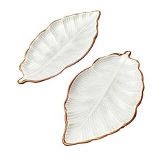 two white and gold leaf shaped dishes