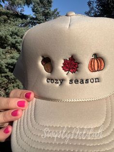 Be the first to welcome fall with this cozy season hat. I have embroidered fall icons on this cute trucker hat. An acorn, fall leaf and a pumpkin to give you all the fall vibe feels!  This stylish trucker hat is embroidered by me from high-quality thread and features intricate embroidery detail that adds a personalized touch to your everyday look for this cozy season.  Whether you're treating yourself or looking for a hat to wear to the pumpkin patch, this fall style will definitely  stand out t Trendy Fall Snapback Baseball Cap, Trendy Fall Baseball Cap, Cozy Fall Cap, Brown Fall Baseball Cap For Outdoor, Fall Outdoor Baseball Cap, Cute Beanie Hats For Fall, Casual Trucker Hat For Fall, Casual Adjustable Snapback Hat For Fall, Cute Brown Hat For Fall