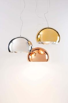 three different colored lights hanging from the ceiling