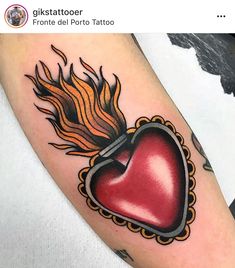 a red heart with flames on the side of its arm is shown in this tattoo design